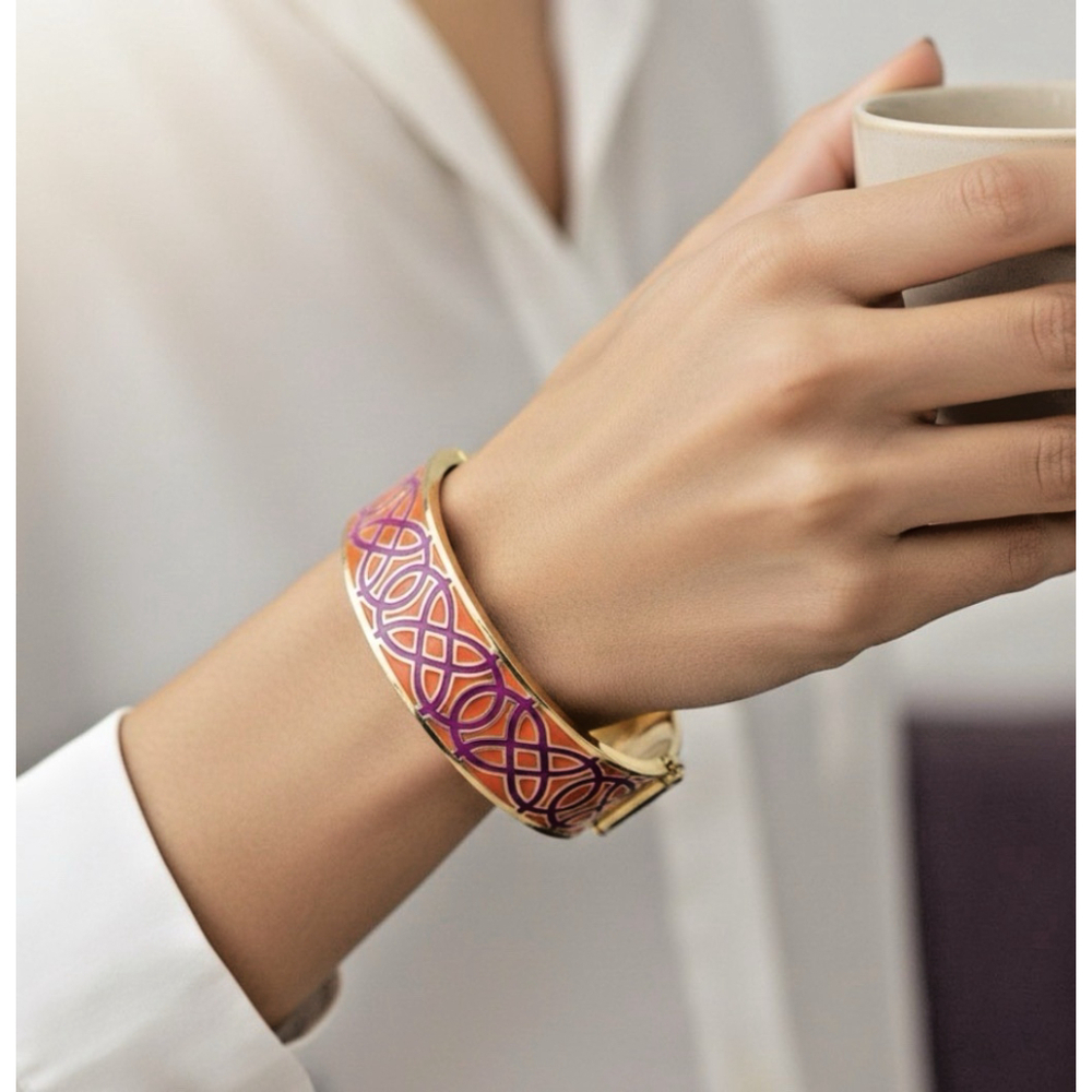 This Stella & Dot hinged bangle features vibrant orange and pink enamel with lux